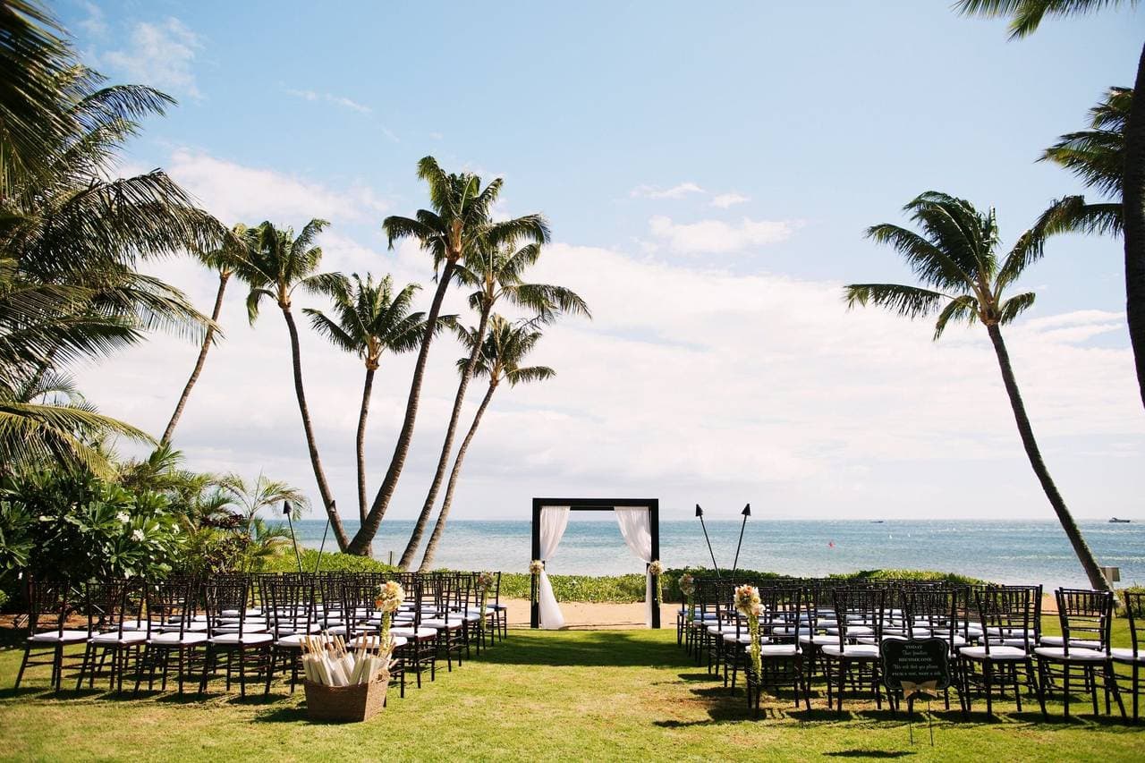 Photographer capturing a couple embracing on a Kihei, HI beach for Sugar Beach Events in Maui by Salt Drifter Photography.