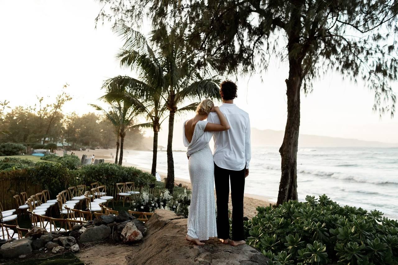 Photographer capturing romantic oceanfront wedding at Surf Club in Paia, HI by Salt Drifter Photography Maui.